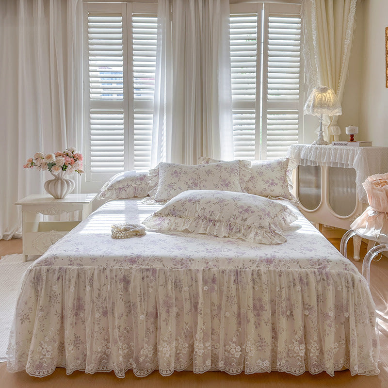 Symmetrical front view of the Lavender Meadow floral bedding set with scalloped lace bed skirt.