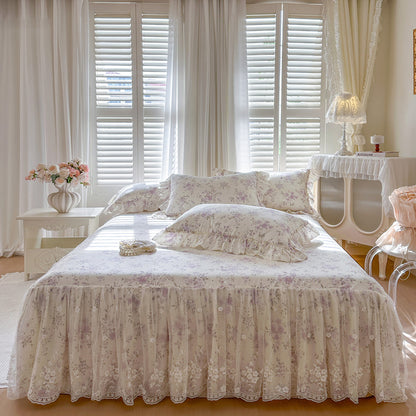 Symmetrical front view of the Lavender Meadow floral bedding set with scalloped lace bed skirt.