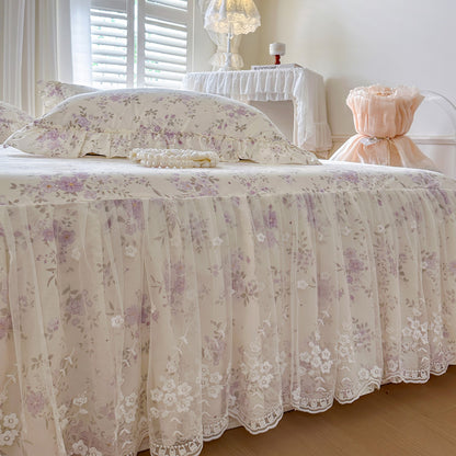 Close-up detail of the intricate white floral embroidery on the Romantic Garden Bed Skirt lace trim.