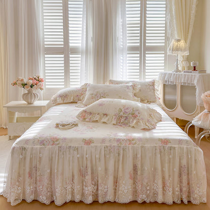 Symmetrical front view of the Cream Blossom bed skirt set with lace trim and matching vintage floral pillows.