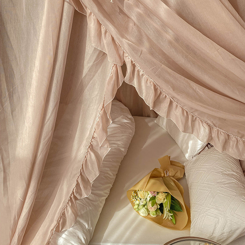 Close-up of the light coffee lace bed canopy curtains flowing into the bed, showing the intricate ruffle trim and the soft texture of the fabric.