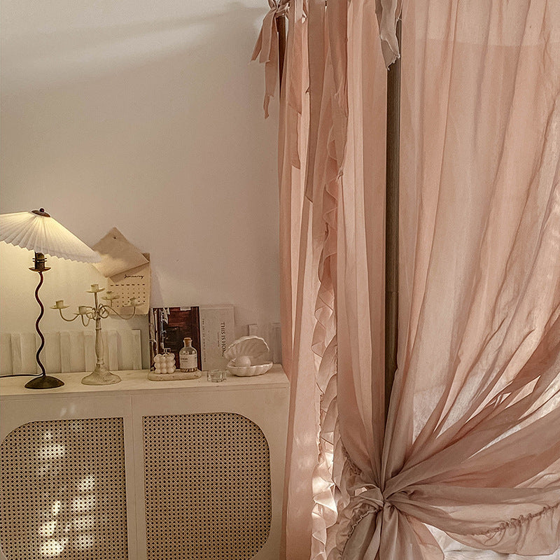 Detail view of the light coffee sheer ruffled drapes, with a soft pleating and cascading folds that add a romantic feel to the bedroom.