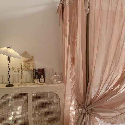 Detail view of the light coffee sheer ruffled drapes, with a soft pleating and cascading folds that add a romantic feel to the bedroom.