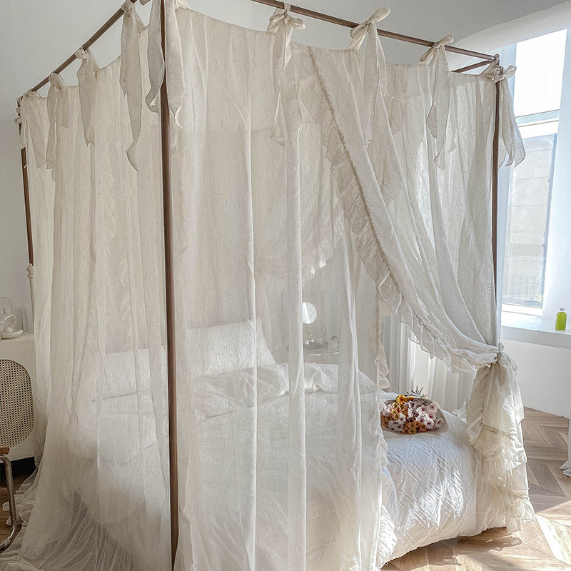 Close-up of the natural linen-colored ruffled bed drapes, with a subtle texture and delicate ties on the top, blending with a modern bedroom style.