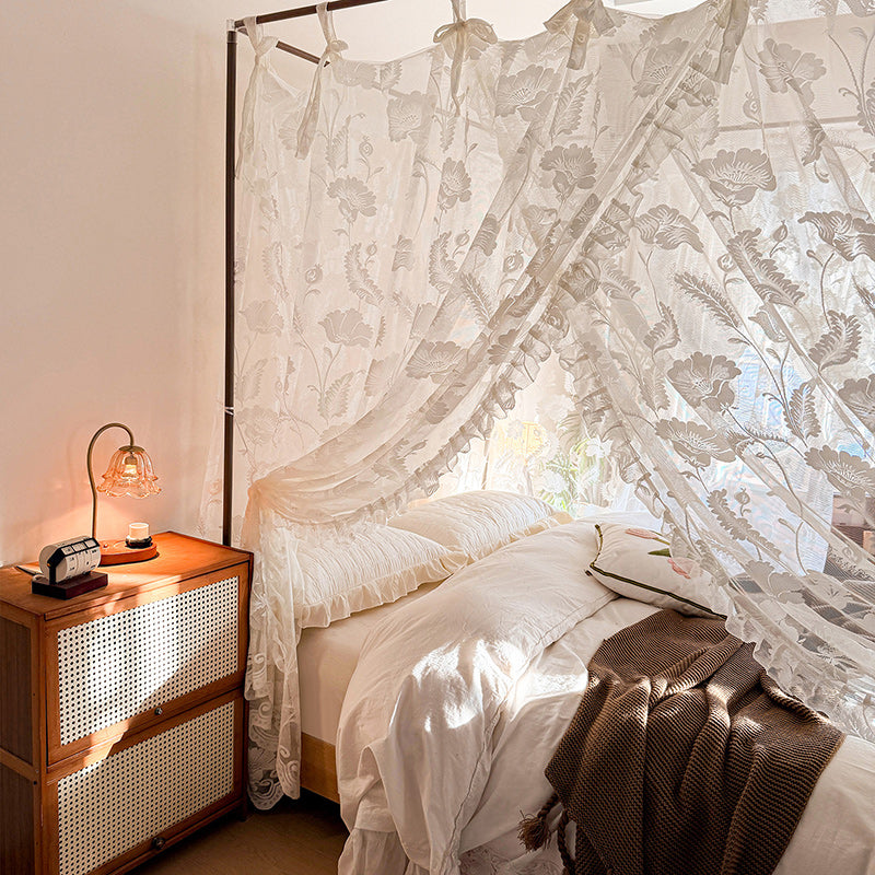 Bedroom with a canopy bed and wooden nightstand
