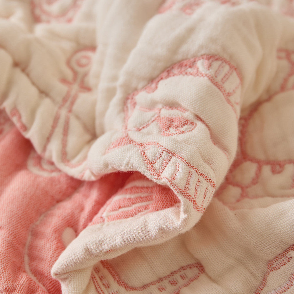 Close-up of sea life cotton muslin blanket showing soft padded texture and jacquard stitching