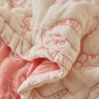 Close-up of sea life cotton muslin blanket showing soft padded texture and jacquard stitching