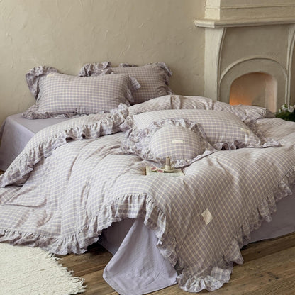 Lavender plaid ruffle bedding set displayed on bed