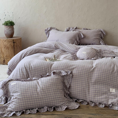 Close-up of ruffled lavender plaid pillowcase and comforter