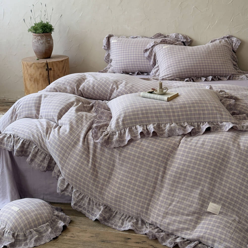 Lavender plaid bedding set with ruffled edges in sunlit room