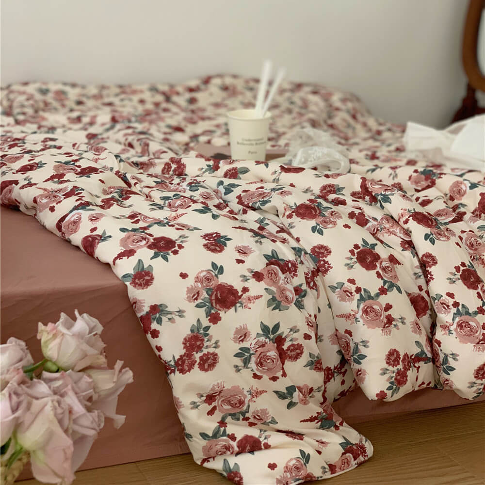 Soft and Romantic Vintage Rose Knit Cotton Bedding Set styled with a matching pink-taupe sheet.