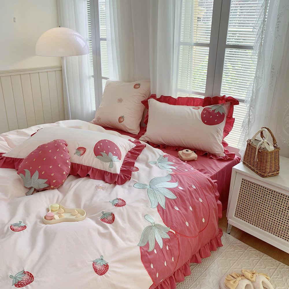 Bedroom with strawberry-themed bedding and decor