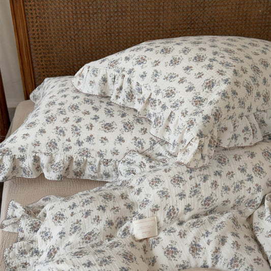 Vintage bouquet duvet cover set with ruffled cotton muslin pillows and muted floral pattern