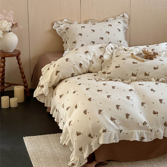 Bear print cotton muslin bedding set with ruffled pillowcase and brown flat sheet on bed