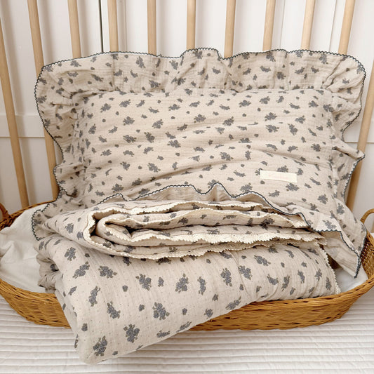 blue blossom kids comforter and ruffled pillow on toddler bed