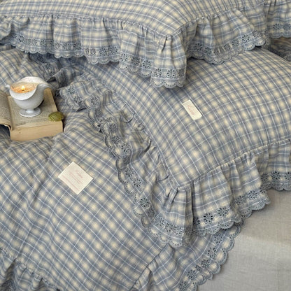 Layered view of dusty blue plaid bedding set with matching pillowcases