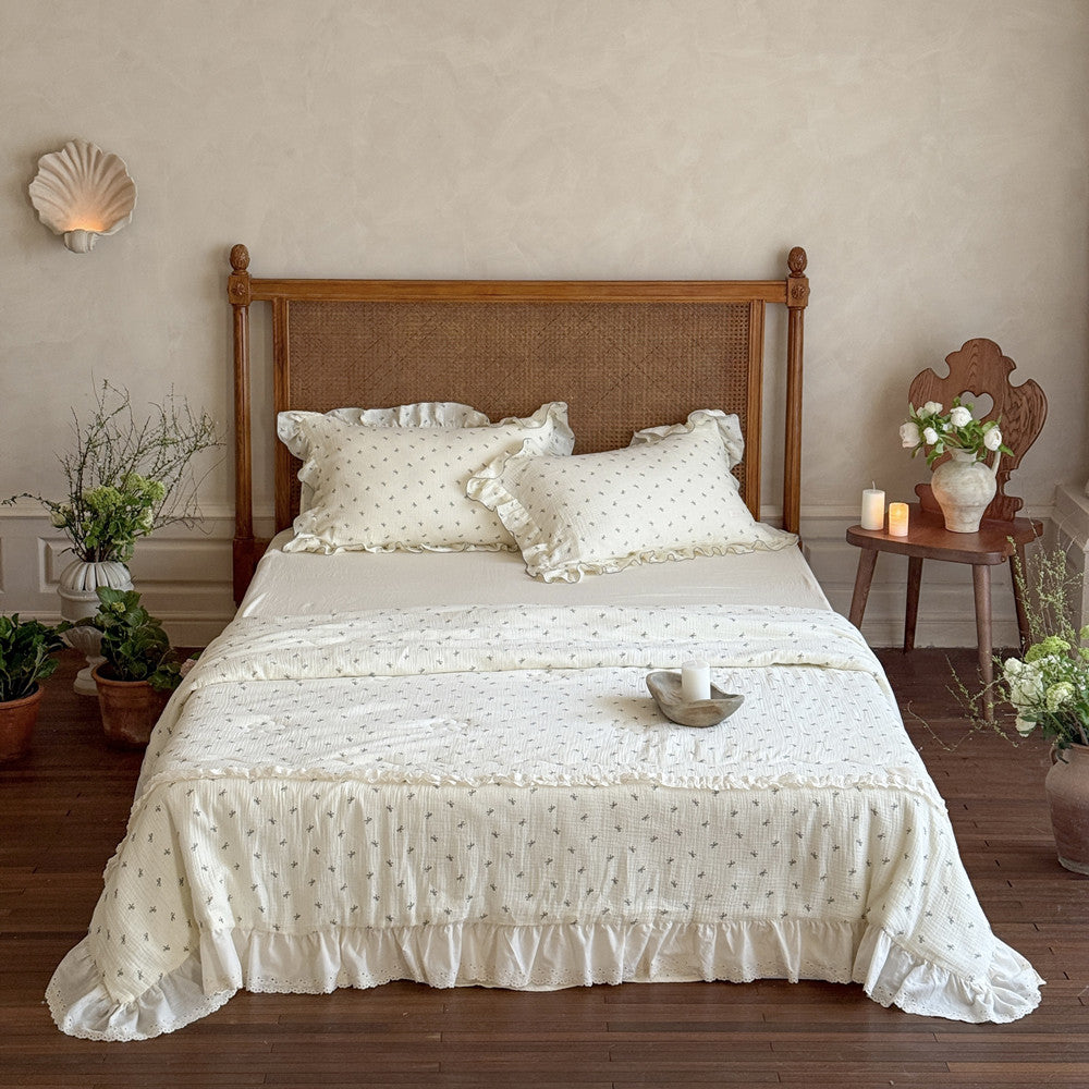 Girly bow ruffle cotton comforter styled on a full bed in bright natural light