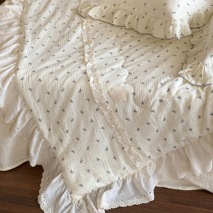 Close-up of ruffled lace trim on bow print cotton comforter