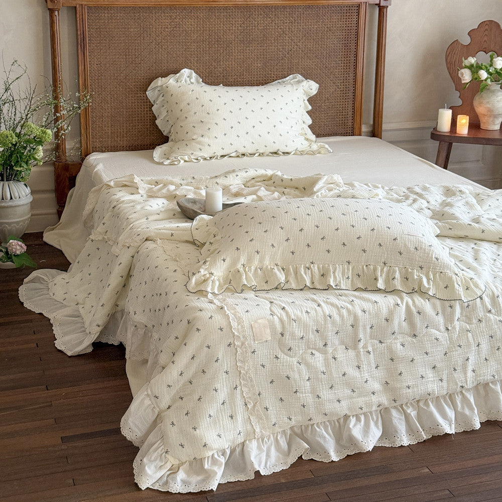 Ruffled comforter and matching bow print pillow with cozy texture
