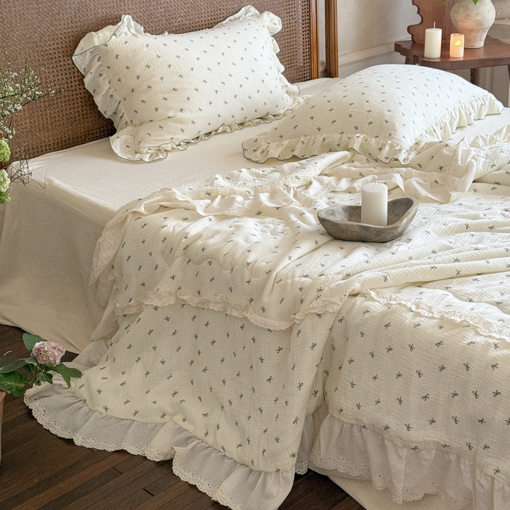 Lightweight cotton comforter with bow print and ruffled trim, styled in a cozy bedroom setting – Bow Ruffle Cotton Comforter