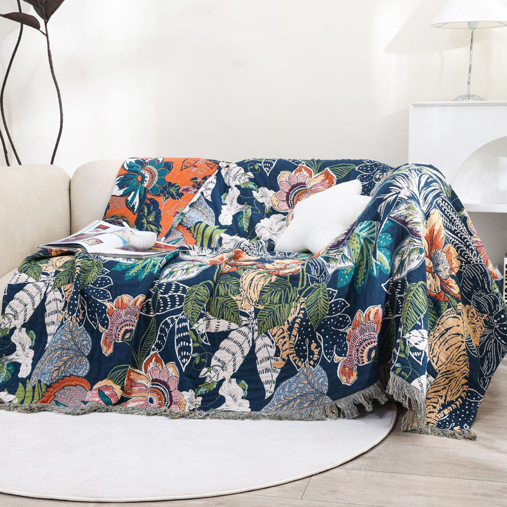 Jaguar jungle cotton throw blanket draped over a sofa