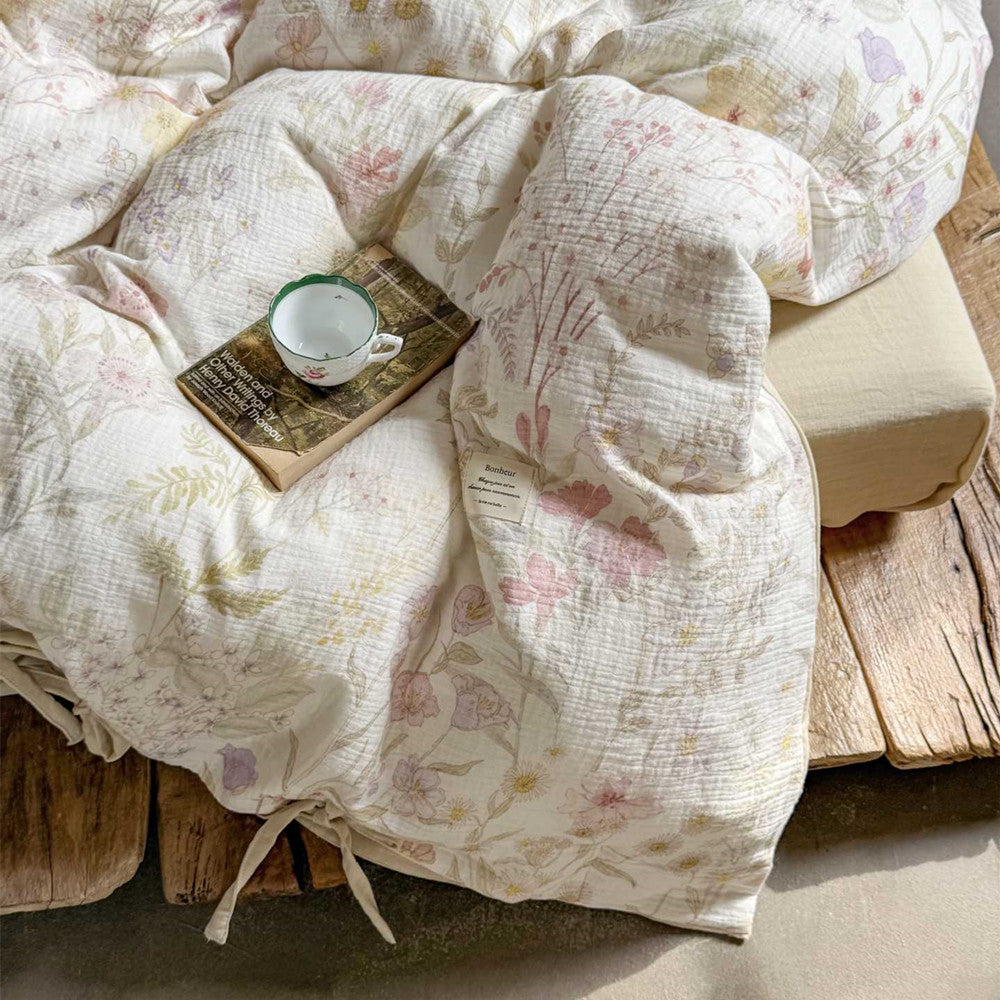 Close-up of crinkled cotton gauze duvet cover in floral blush white