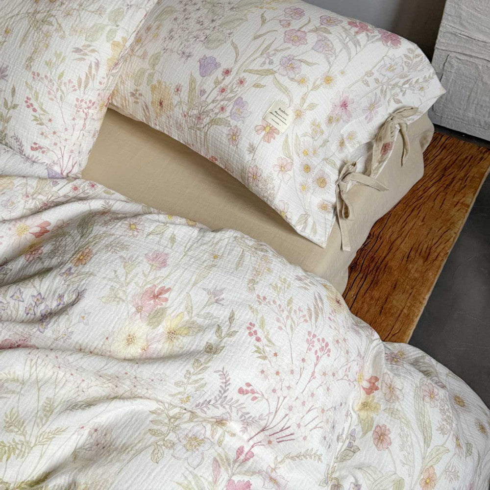 Reversible blush floral duvet cover with soft solid cotton back in neutral ivory