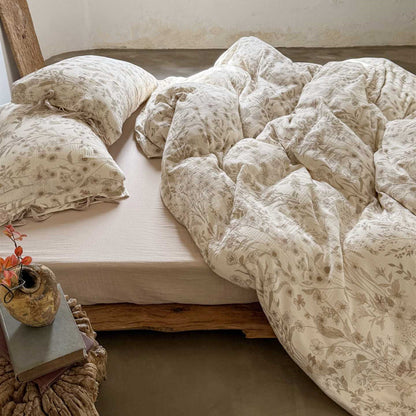 Side view of reversible floral cotton gauze bedding set on wooden bed