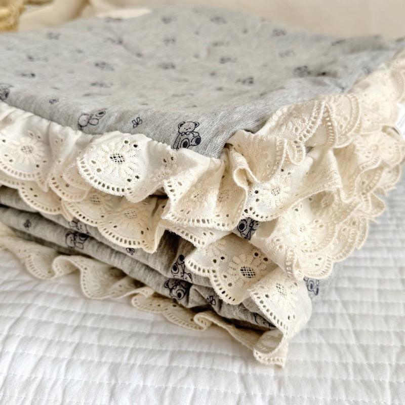 Folded baby comforter with eyelet lace trim