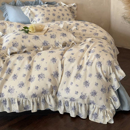 French country ruffled bedding set styled on a bed, with a close focus on the soft, flowing ruffle details of the duvet cover and pillow shams.