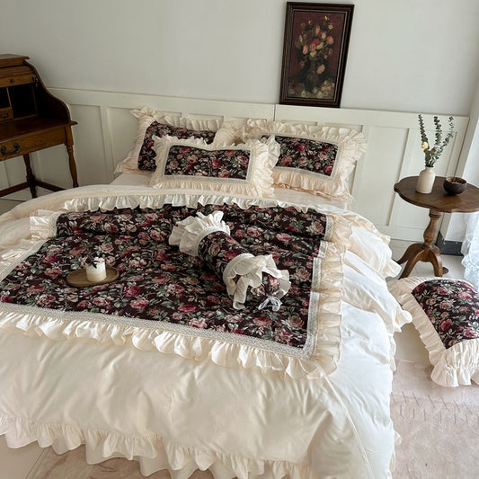 Front view of romantic dark cotton bedding with vintage roses