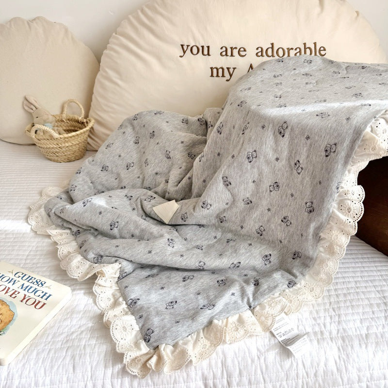 Cotton jersey baby comforter displayed on nursery bed