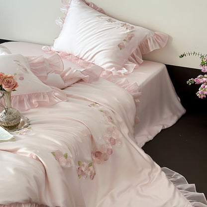 Satin ruffle and rose embroidery detail on duvet