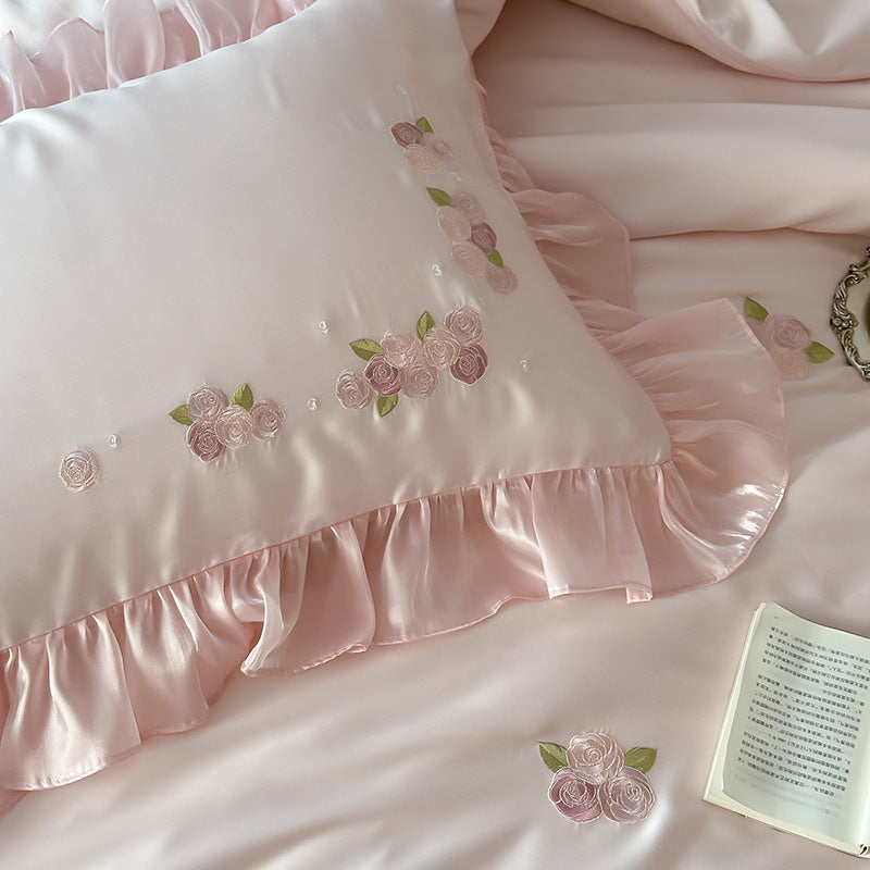 Ruffled pink Tencel pillow with floral embroidery