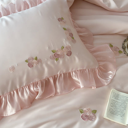 Ruffled pink Tencel pillow with floral embroidery