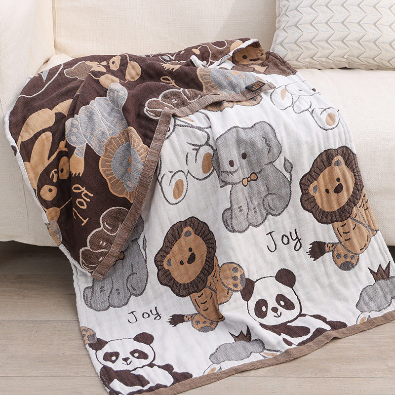 Reversible kids jacquard blanket showing white and brown animal sides