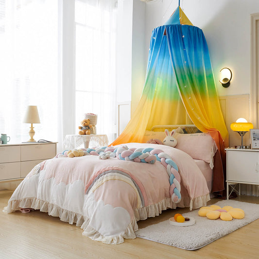 Full shot of a rainbow kids bed canopy over a bed, creating a bright and whimsical feel.