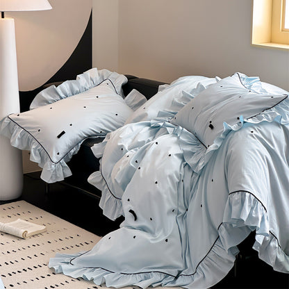 Side view of blue bedding with ruffled trim and heart details