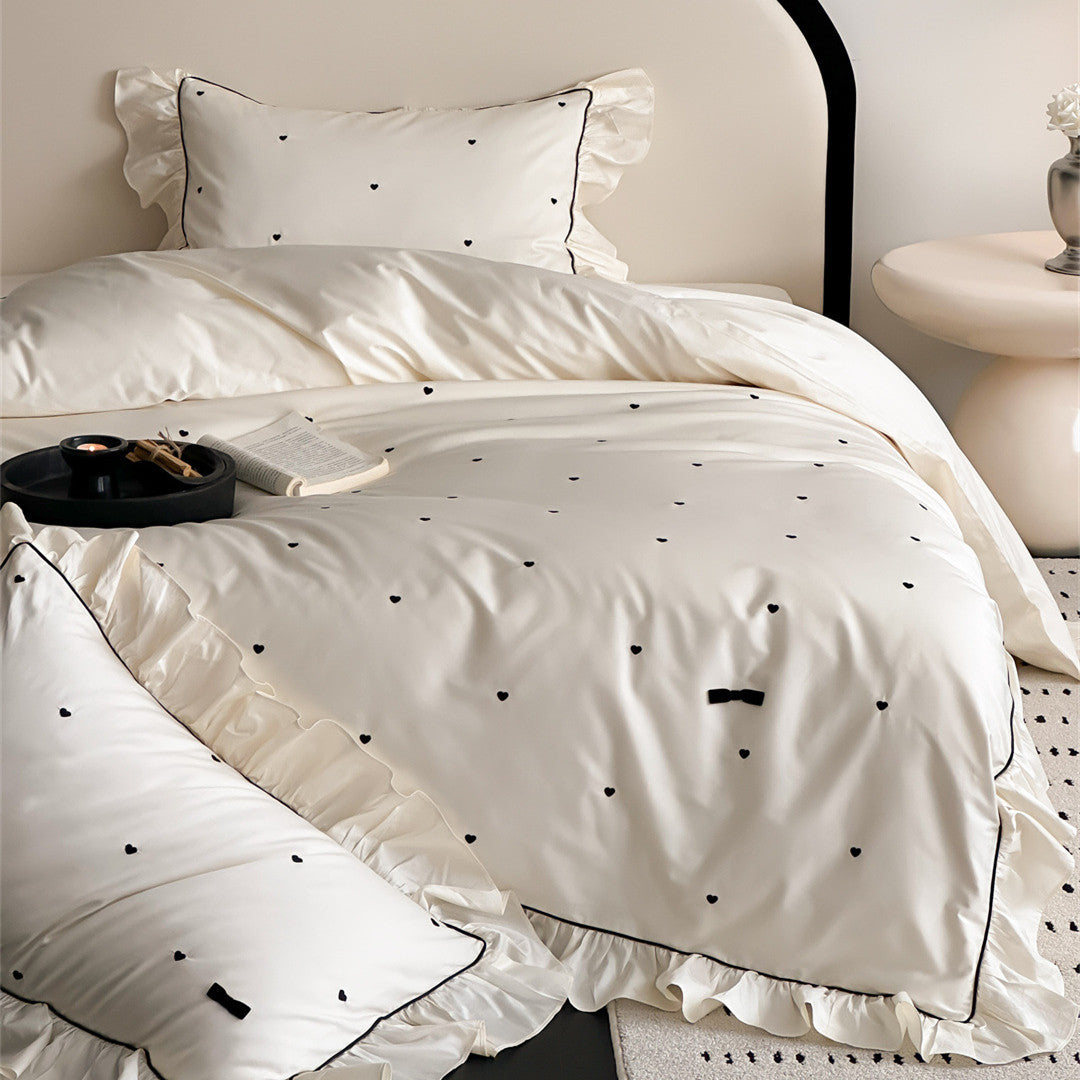 Cozy ivory cotton bedding set with ruffles and embroidered hearts