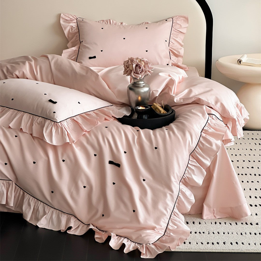 Pink ruffled bedding set with black embroidered hearts