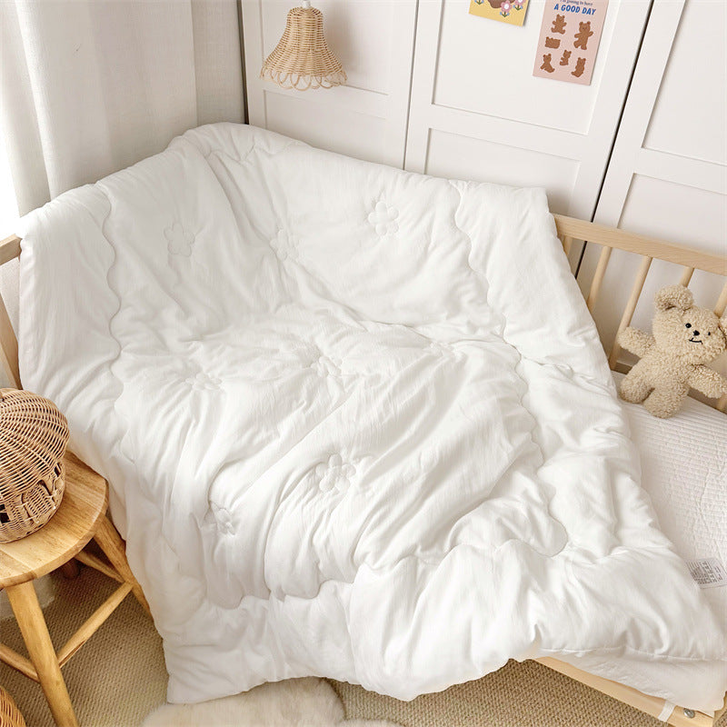Soft toddler comforter insert laid flat on a toddler bed, ideal as an inner quilt for duvet covers