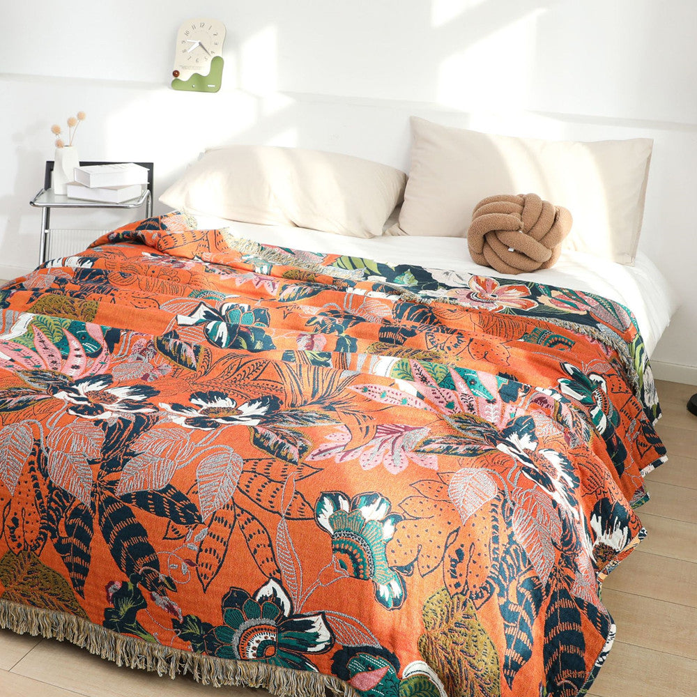 Orange reverse side of jaguar jungle cotton throw blanket on bed