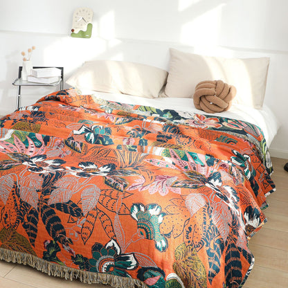 Orange reverse side of jaguar jungle cotton throw blanket on bed