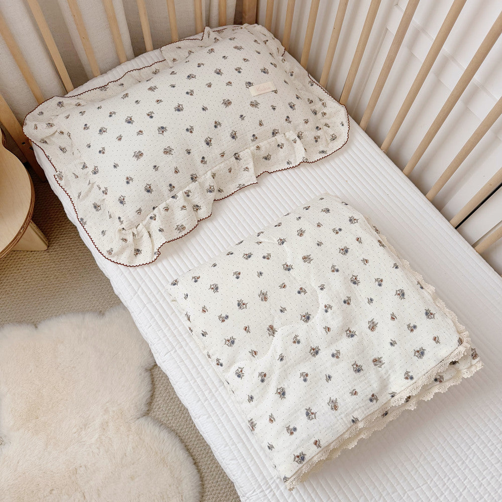 Top-down view of toddler bed with comforter set