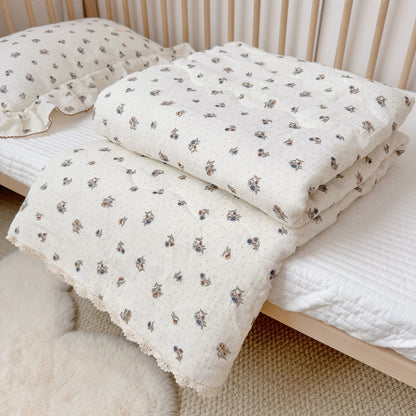 vintage dot floral Comforter folded at end of crib