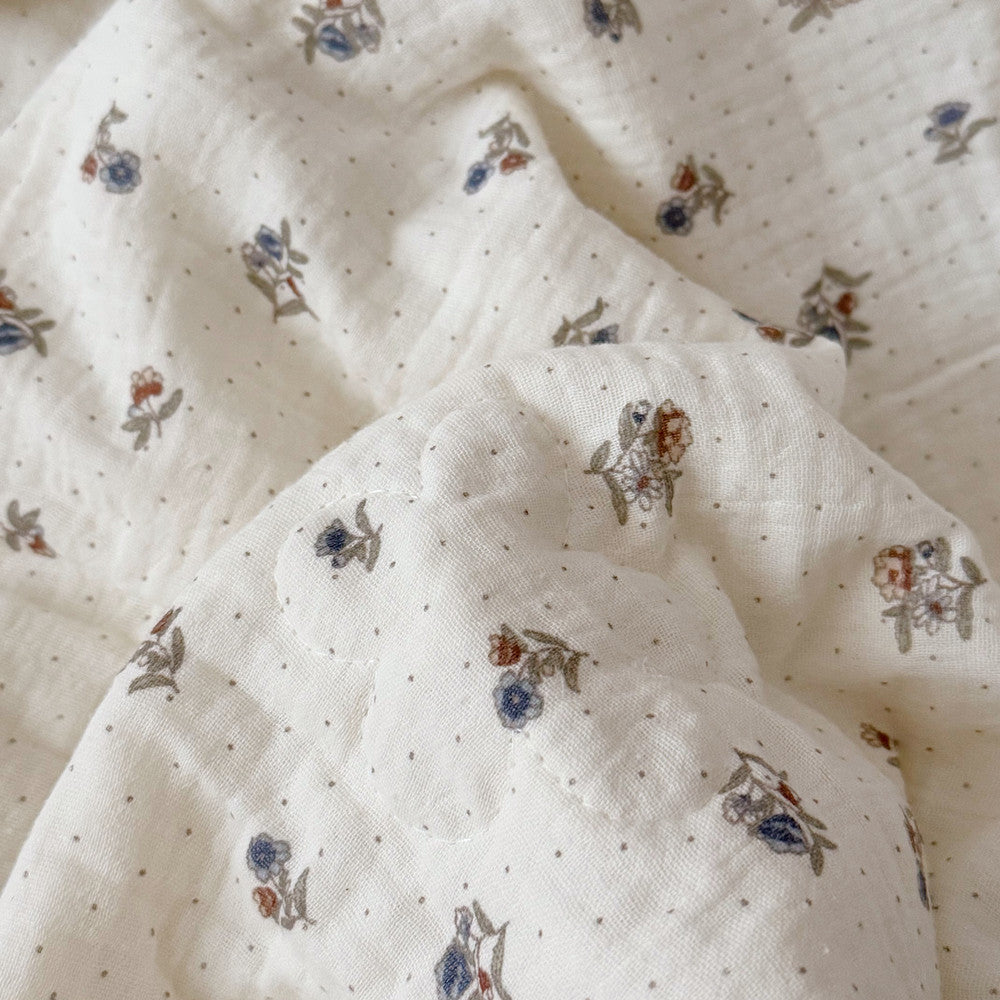 Close-up of floral print and flower quilting